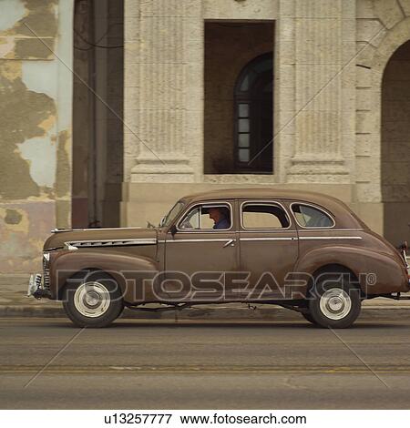 Person sitting in an antique car, Havana, Cuba View Large Photo Image Stock Photo - Person sitting in an antique car, Havana, Cuba. Fotosearch
