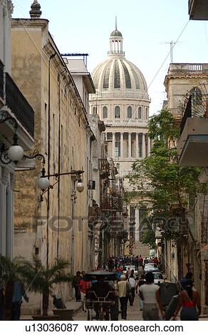 Stock Photo - Rear view of people walking in a narrow street, Havana, Cuba. Fotosearch