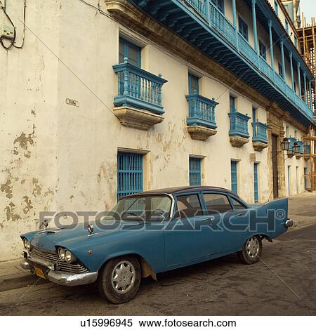 Antique car parked in front of a building, Havana, Cuba View Large Photo Image Stock Photography - Antique car parked in front of a building, Havana, Cuba. Fotosearch