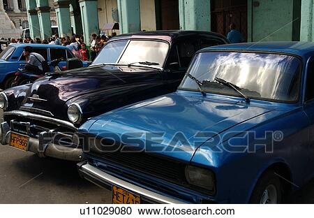 Front view of vintage cars parked outside a building, Havana, Cuba View Large Photo Image Stock Image - Front view of vintage cars parked outside a building, Havana, Cuba. Fotosearch