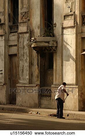 Rear view of a man sweeping the street, Havana, Cuba View Large Photo Image Stock Image - Rear view of a man sweeping the street, Havana, Cuba. Fotosearch