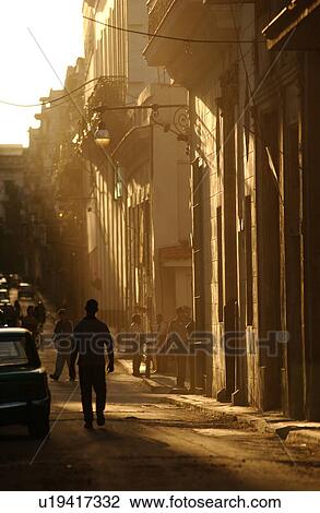 Silhouette of a man walking on the sidewalk, Havana, Cuba View Large Photo Image Stock Image - Silhouette of a man walking on the sidewalk, Havana, Cuba. Fotosearch