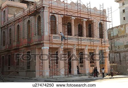 Stock Image - View of scaffolding on the facade of a commercial building, Havana, Cuba. Fotosearch