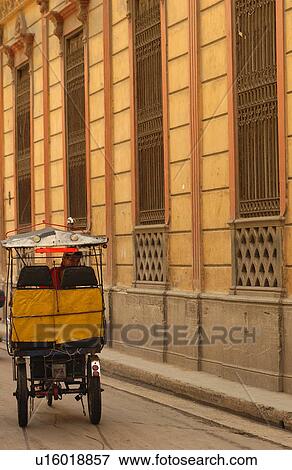 Rear view of a man riding a Pedicab, Havana, Cuba View Large Photo Image Stock Photo - Rear view of a man riding a Pedicab, Havana, Cuba. Fotosearch