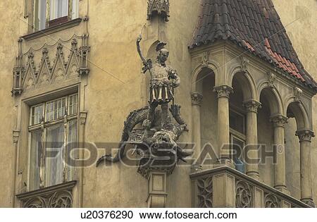 Stock Image - Corner of an ancient building with a statue in Prague. Fotosearch