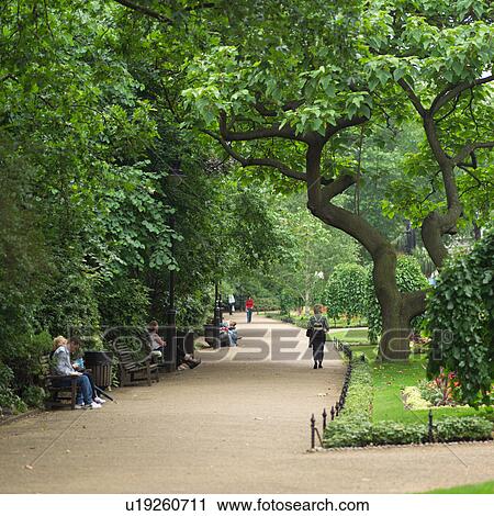 Stock Image - People at a park in London, England. Fotosearch