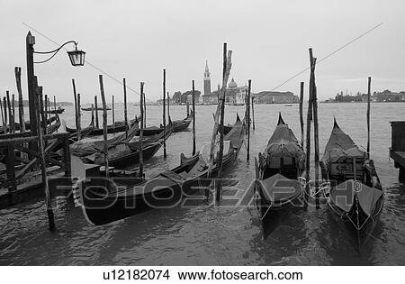 Picture - Array of gondolas docked at a canal in Venice, Italy. Fotosearch