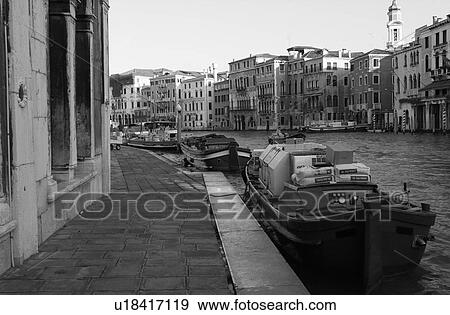 Stock Photo - Gondolas docked at the banks of a canal in Venice, Italy. Fotosearch