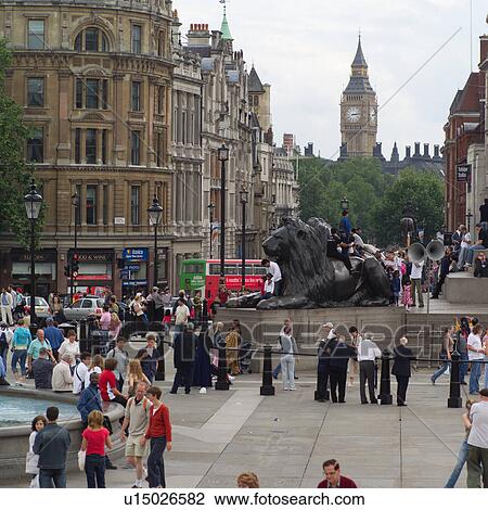 Stock Image - People walking in Trafalgar square, London, England. Fotosearch