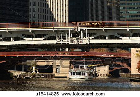 Boat passing under a bridge View Large Photo Image Stock Photography - Boat passing under a bridge. Fotosearch