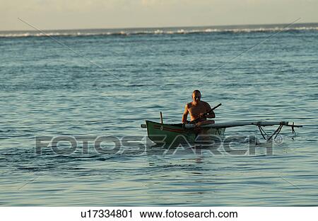 A man rowing a boat in the sea View Large Photo Image Stock Image - A man rowing a boat in the sea. Fotosearch