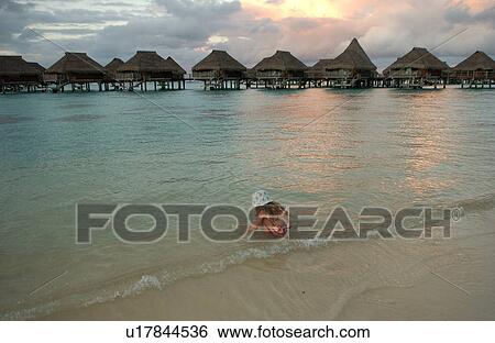 A young girl playing on a beach View Large Photo Image Stock Photograph - A young girl playing on a beach. Fotosearch