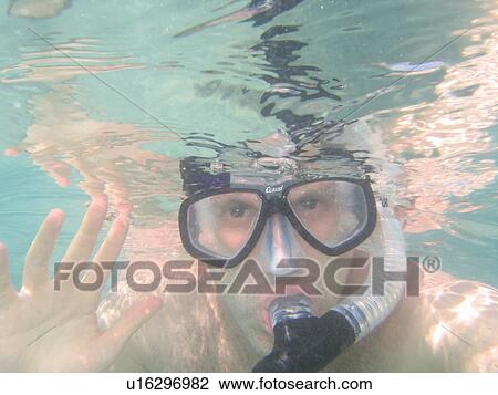 Close-up of a young man wearing scuba gear swimming underwater View Large Photo Image Stock Image - Close-up of a young man wearing scuba gear swimming underwater. Fotosearch