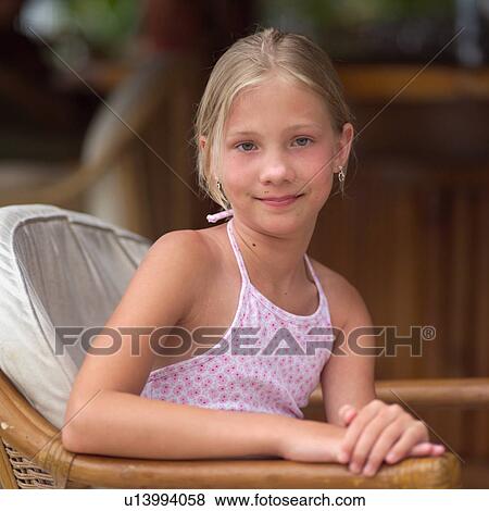 Stock Photo - Girl Looking at Camera with Hands Crossed at Moorea in Tahiti. Fotosearch