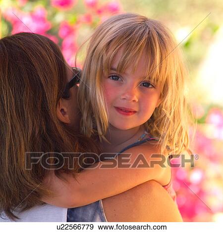Stock Photo - Mother cuddling with her daugher. Fotosearch