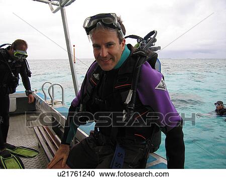 Portrait of a young man wearing scuba gear sitting in a boat View Large Photo Image Stock Image - Portrait of a young man wearing scuba gear sitting in a boat. Fotosearch
