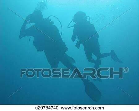 Stock Image - Underwater view of two scuba divers. Fotosearch