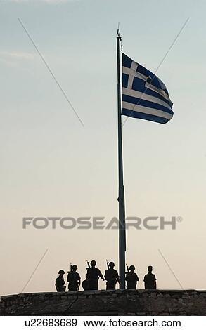Monument of soldiers standing under the Greek flag in Athens, Greece View Large Photo Image Stock Photo - Monument of soldiers standing under the Greek flag in Athens, Greece. Fotosearch