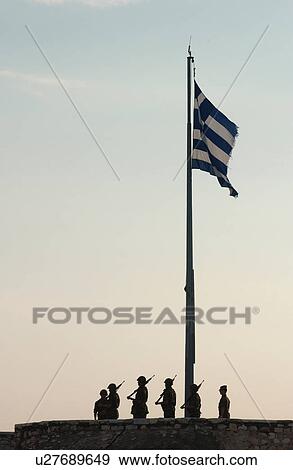 Monument of soldiers standing under the Greek flag in Athens, Greece View Large Photo Image Stock Photo - Monument of soldiers standing under the Greek flag in Athens, Greece. Fotosearch