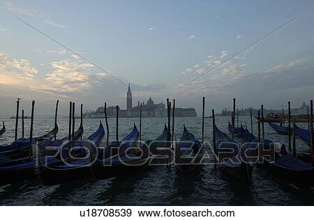 Stock Photo - Array of gondolas docked at a canal in Venice, Italy. Fotosearch