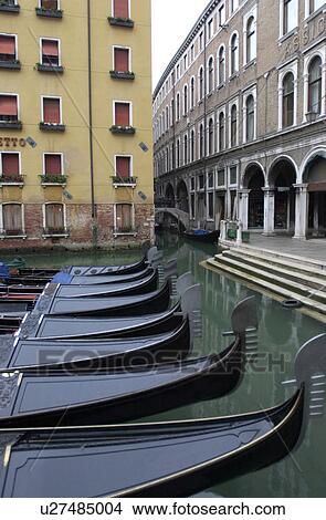 Array of gondolas docked at a canal in Venice, Italy View Large Photo Image Picture - Array of gondolas docked at a canal in Venice, Italy. Fotosearch
