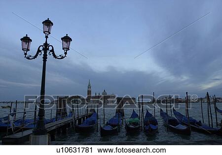 Array of gondolas docked at a canal in Venice, Italy View Large Photo Image Stock Image - Array of gondolas docked at a canal in Venice, Italy. Fotosearch