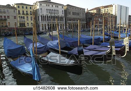 Array of gondolas docked at a canal in Venice, Italy View Large Photo Image Stock Photo - Array of gondolas docked at a canal in Venice, Italy. Fotosearch