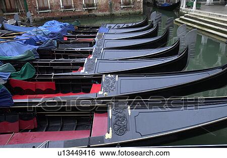 Array of gondolas docked at a canal in Venice, Italy View Large Photo Image Stock Photograph - Array of gondolas docked at a canal in Venice, Italy. Fotosearch