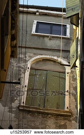 Stock Photo - Low angle view of a closed window of a building in Venice, Italy. Fotosearch