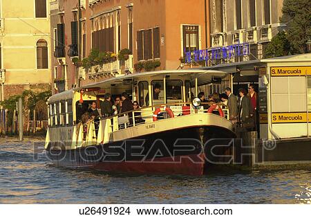 Passenger boat docked on the banks of a canal in Venice, Italy View Large Photo Image Picture - Passenger boat docked on the banks of a canal in Venice, Italy. Fotosearch