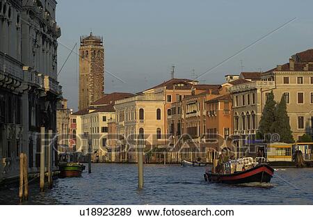 Passenger boat in a canal in Venice, Italy View Large Photo Image Stock Photo - Passenger boat in a canal in Venice, Italy. Fotosearch