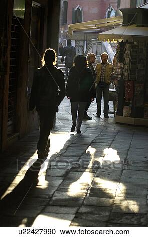 Stock Image - People walking on a street in Venice, Italy. Fotosearch