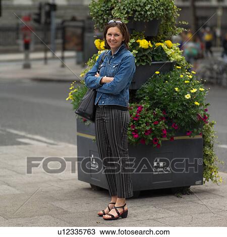 Brunette standing with arms crossed in Ireland View Large Photo Image Stock Image - Brunette standing with arms crossed in Ireland. Fotosearch