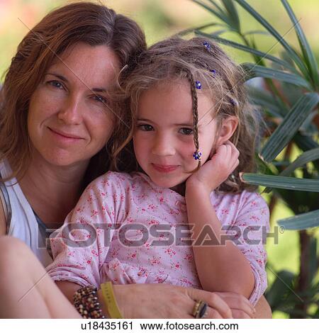 Mother cuddling with her daugher View Large Photo Image Stock Image - Mother cuddling with her daugher. Fotosearch