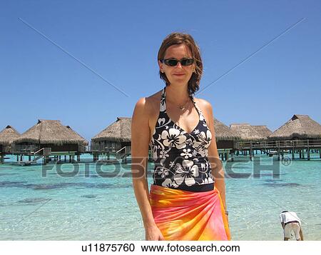 Portrait of a young woman standing on a beach View Large Photo Image Stock Image - Portrait of a young woman standing on a beach. Fotosearch