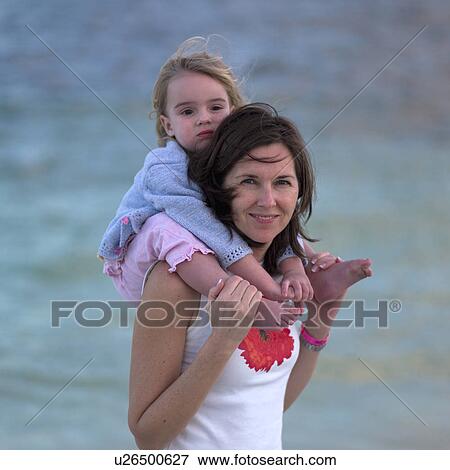 Stock Photo - Woman and Daughter at Beach. Fotosearch