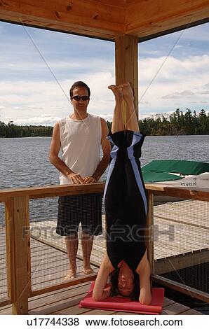 Woman doing yoga outdoors on dock View Large Photo Image Stock Photo - Woman doing yoga outdoors on dock. Fotosearch