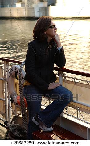Woman standing at a railing of a boat View Large Photo Image Stock Photo - Woman standing at a railing of a boat. Fotosearch