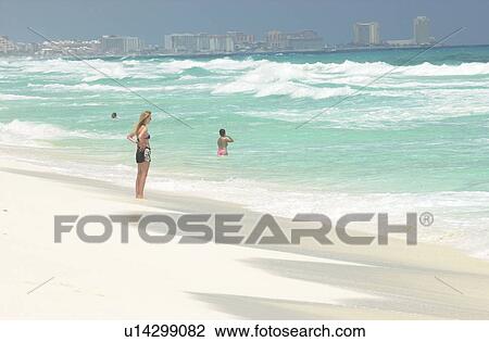 Stock Image - People at the beach in Mexico. Fotosearch