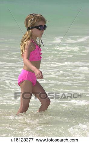 Side profile of a young girl standing on the beach in Mexico View Large Photo Image Stock Photo - Side profile of a young girl standing on the beach in Mexico. Fotosearch