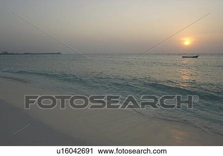 Stock Image - Sunset over a beach in Mexico. Fotosearch
