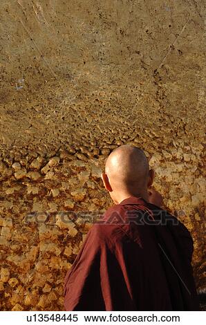 Stock Photography - Monk in front of Golden Rock. Fotosearch