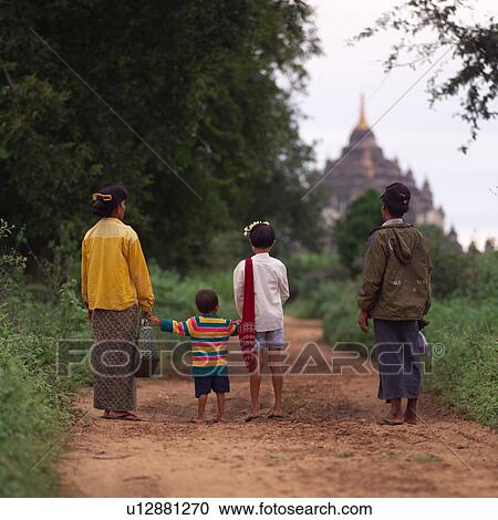 Burmese family standing on a path looking at Buddhist Temple View Large Photo Image Stock Image - Burmese family standing on a path looking at Buddhist Temple. Fotosearch
