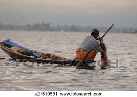 Stock Image - Crouching fisherman. Fotosearch