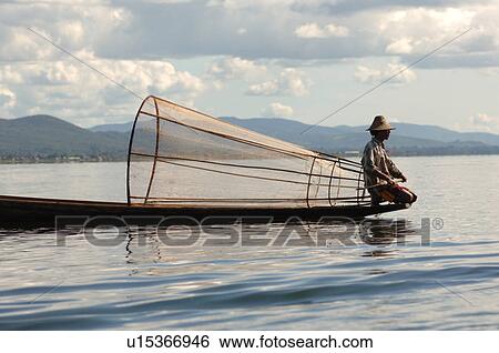 Fisherman in row boat View Large Photo Image Stock Photograph - Fisherman in row boat. Fotosearch