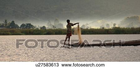 Fisherman leg rowing View Large Photo Image Stock Image - Fisherman leg rowing. Fotosearch