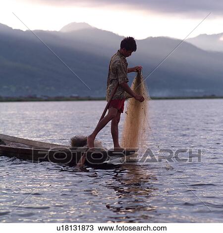 Intha fisherman in his flat-bottomed boat View Large Photo Image Stock Image - Intha fisherman in his flat-bottomed boat. Fotosearch
