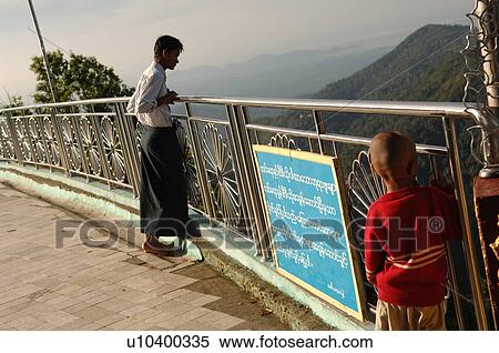 Man and child looking over fencing at Golden Rock View Large Photo Image Stock Photography - Man and child looking over fencing at Golden Rock. Fotosearch