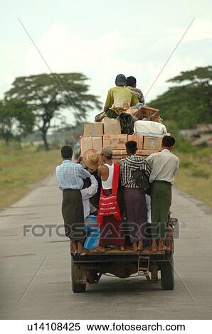 Truck driving away full of people View Large Photo Image Stock Photography - Truck driving away full of people. Fotosearch
