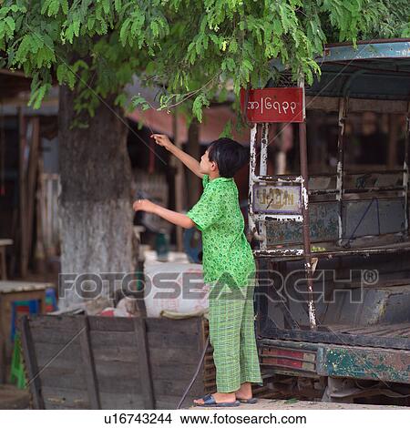 Picture - Woman outside a street market in Mandalay. Fotosearch